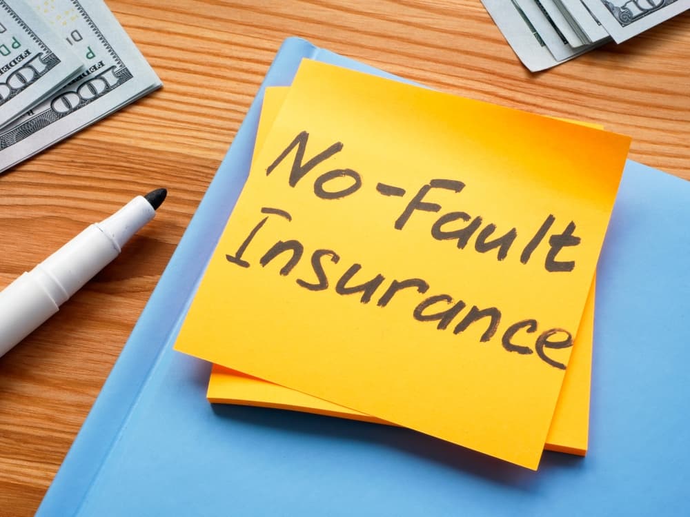 A Sticker with memo No fault insurance and notepad