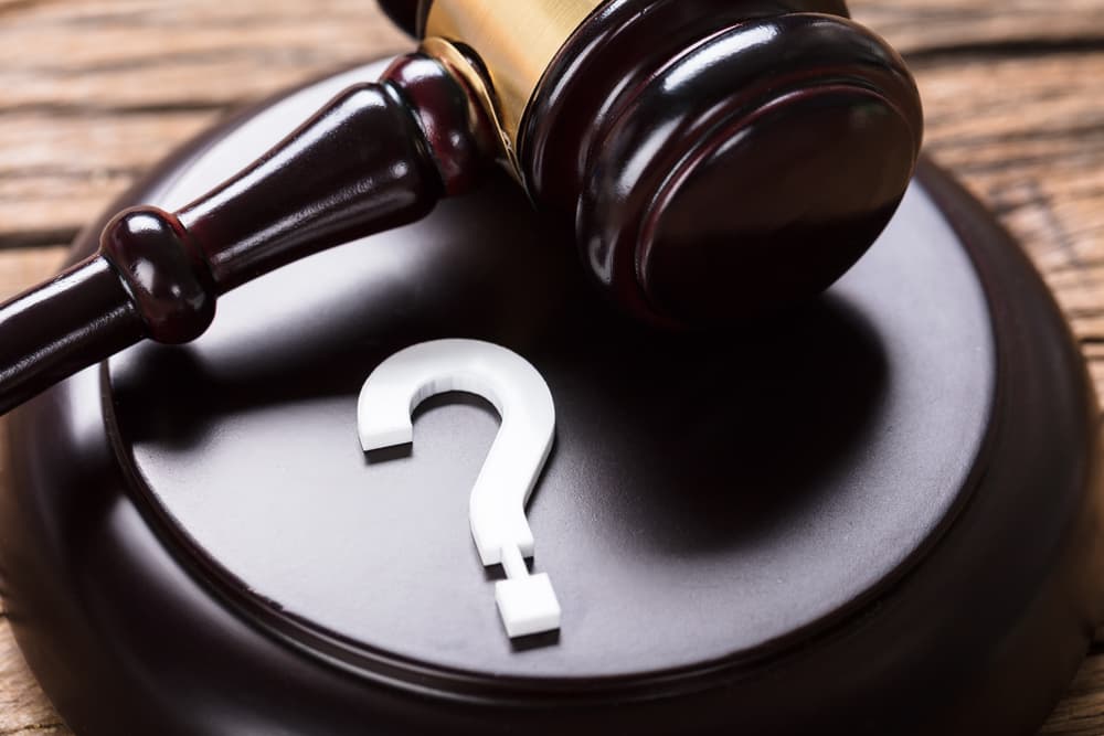 Closeup of question mark and Judge gavel