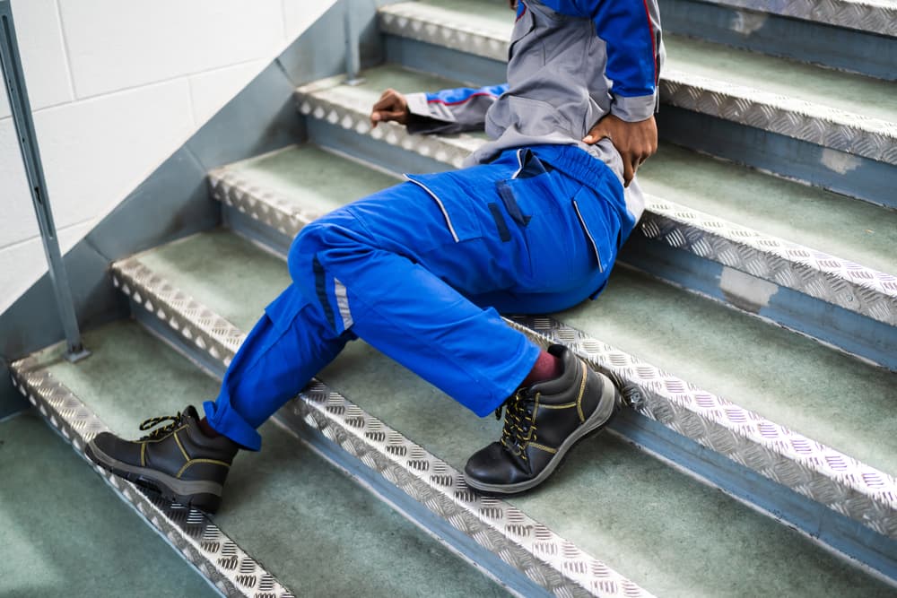 Worker Man Lying On Staircase After Slip And Fall Accident