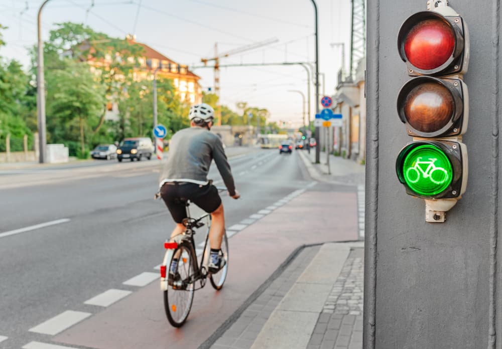 Green bicycle traffic light, symbolizing urban road safety and sustainable city transportation.