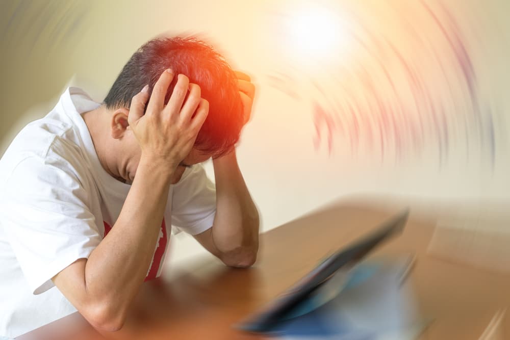 Brain diseases can cause chronic headaches and migraines. A stressed adult male appears tired and depressed, struggling with mental health challenges.