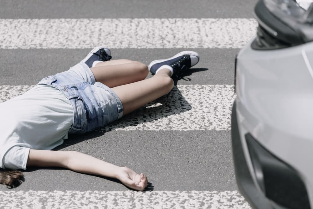 High-angle view of a pedestrian accident scene, showing a child struck by a car at a crosswalk, emphasizing the concept of pedestrian safety and accident awareness.