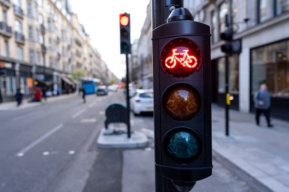 Red bicycle traffic light, highlighting  cycling regulations and road safety measures.