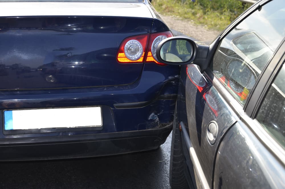 Car collision on a busy city road during a highway traffic jam.







