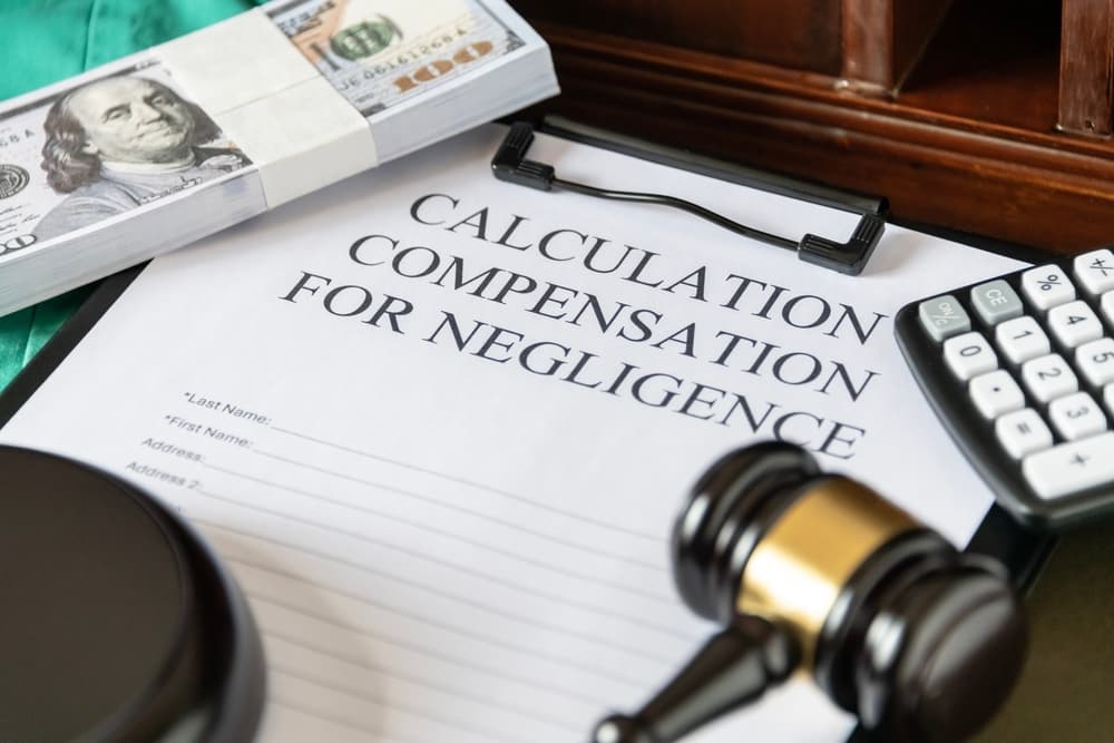 A legal document titled 'Calculating Compensation for Negligence,' featuring a gavel and calculator to symbolize judicial proceedings.