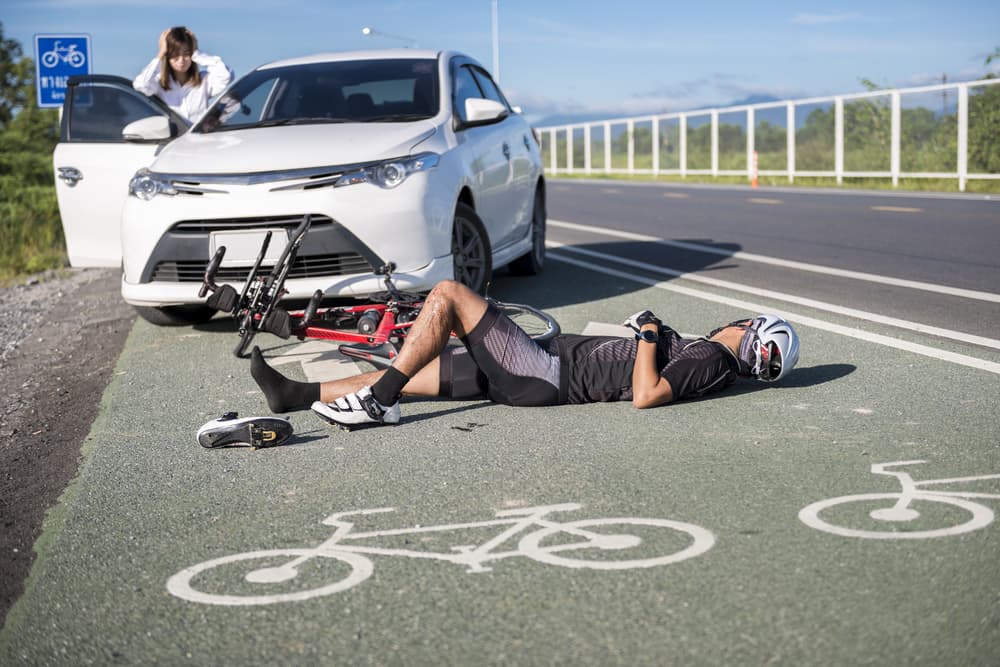 Car and bicycle collision in a bike lane.